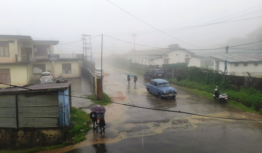 Representative Image: School children shield themselves with umbrellas after a bout of rainfall in Mokokchung town. (Morung File Photo)